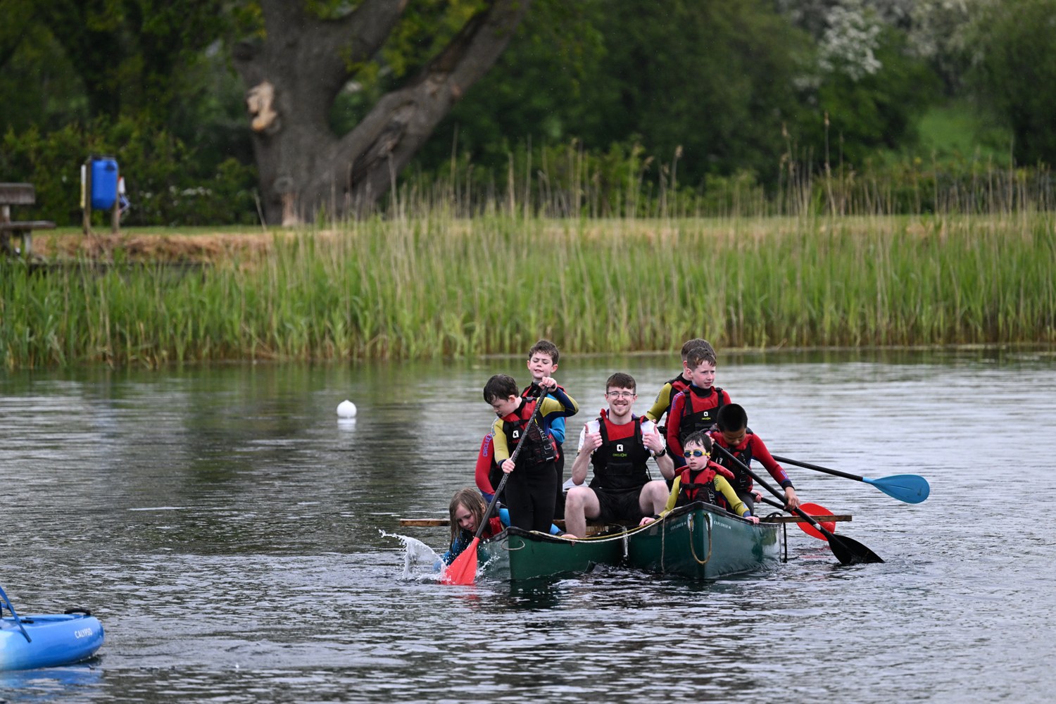 A group paddling a raft together